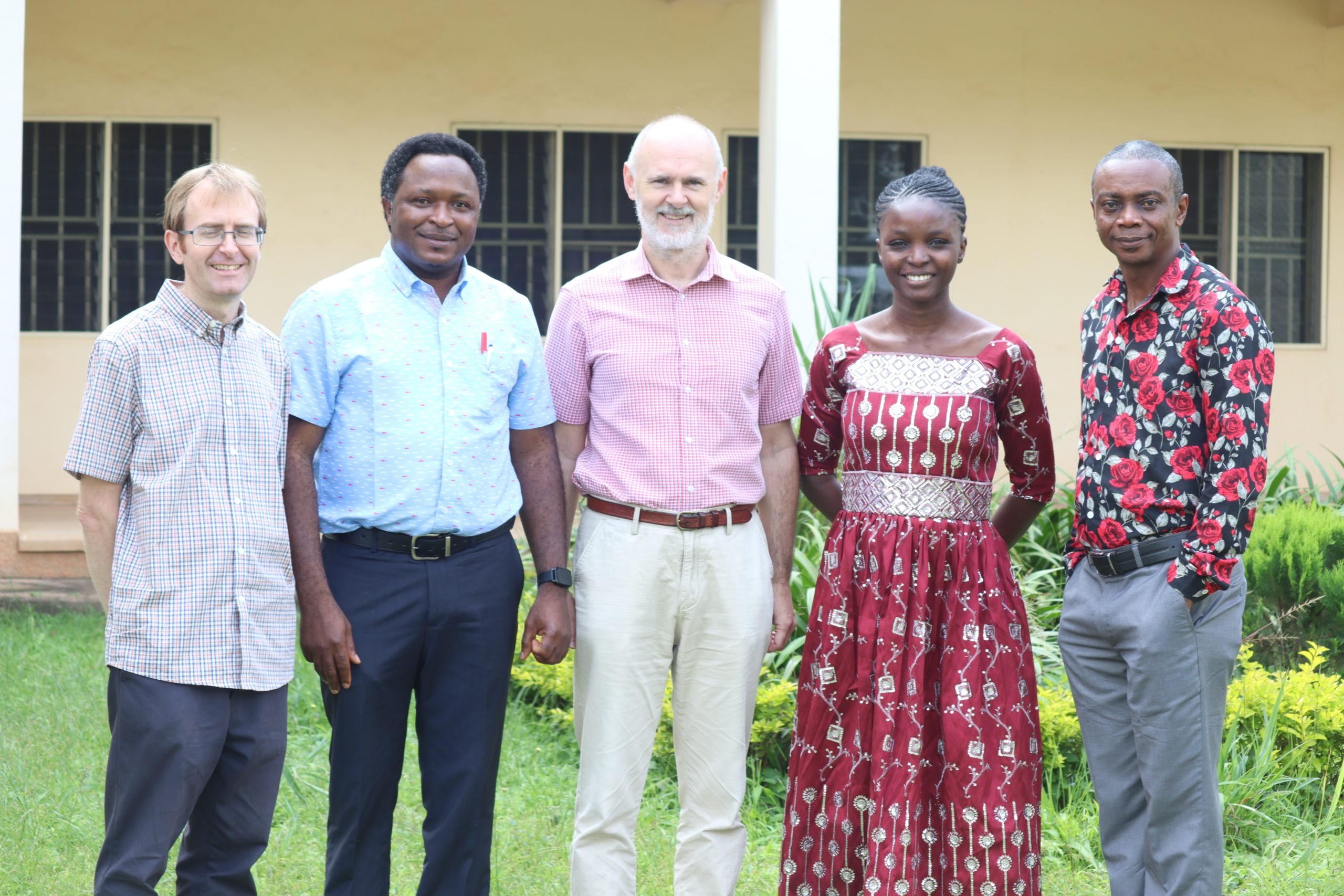 Pelumi stands with two Nigerian and two British men