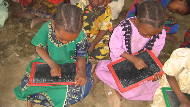 Leafa children write on small chalkboards