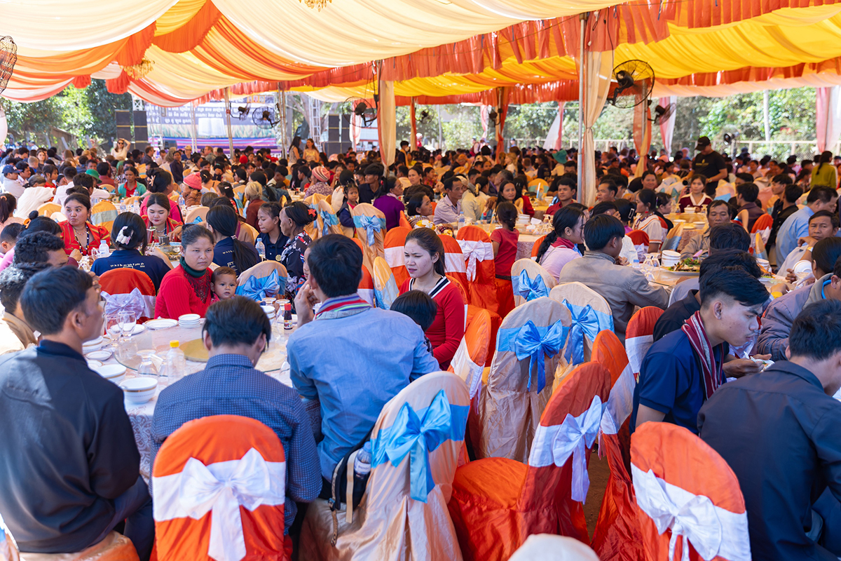 Image of the guests at the Krung New Testament launch, sitting in a marquee awaiting their food