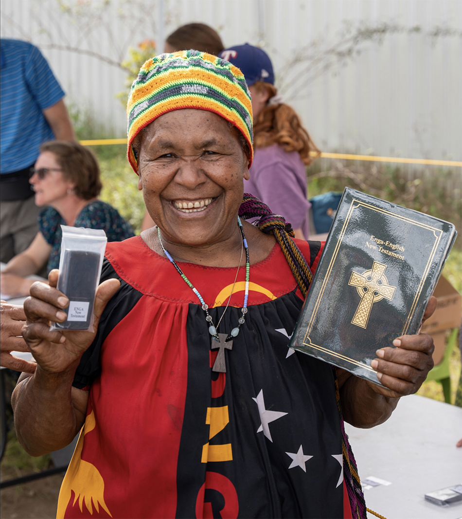 Image of an Enga woman with her Enga New Testament in audio and print versions