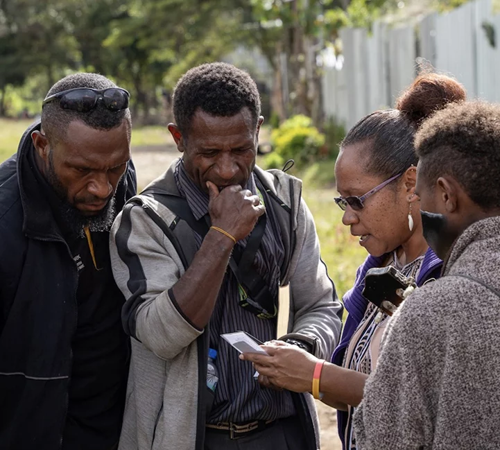 Image of Engan people listening to the audio version of the Enga New Testament at the launch event