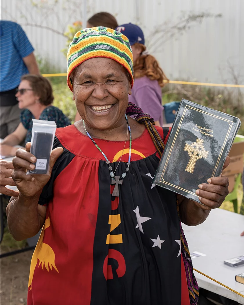 Image of an Engan woman with her audio and print copies of the Enga New Testament