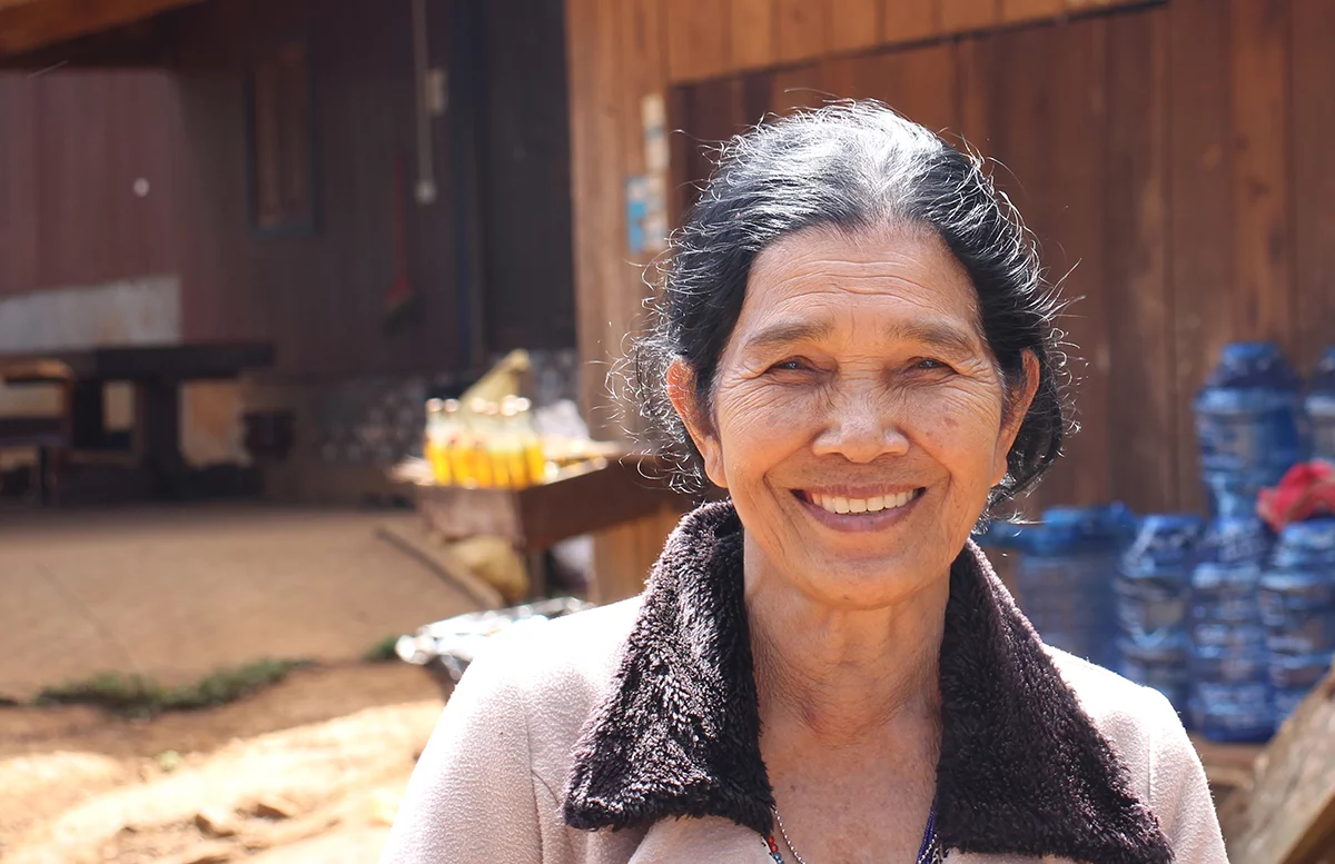 Image of Leun, Lonh’s mother, in front of her village shop