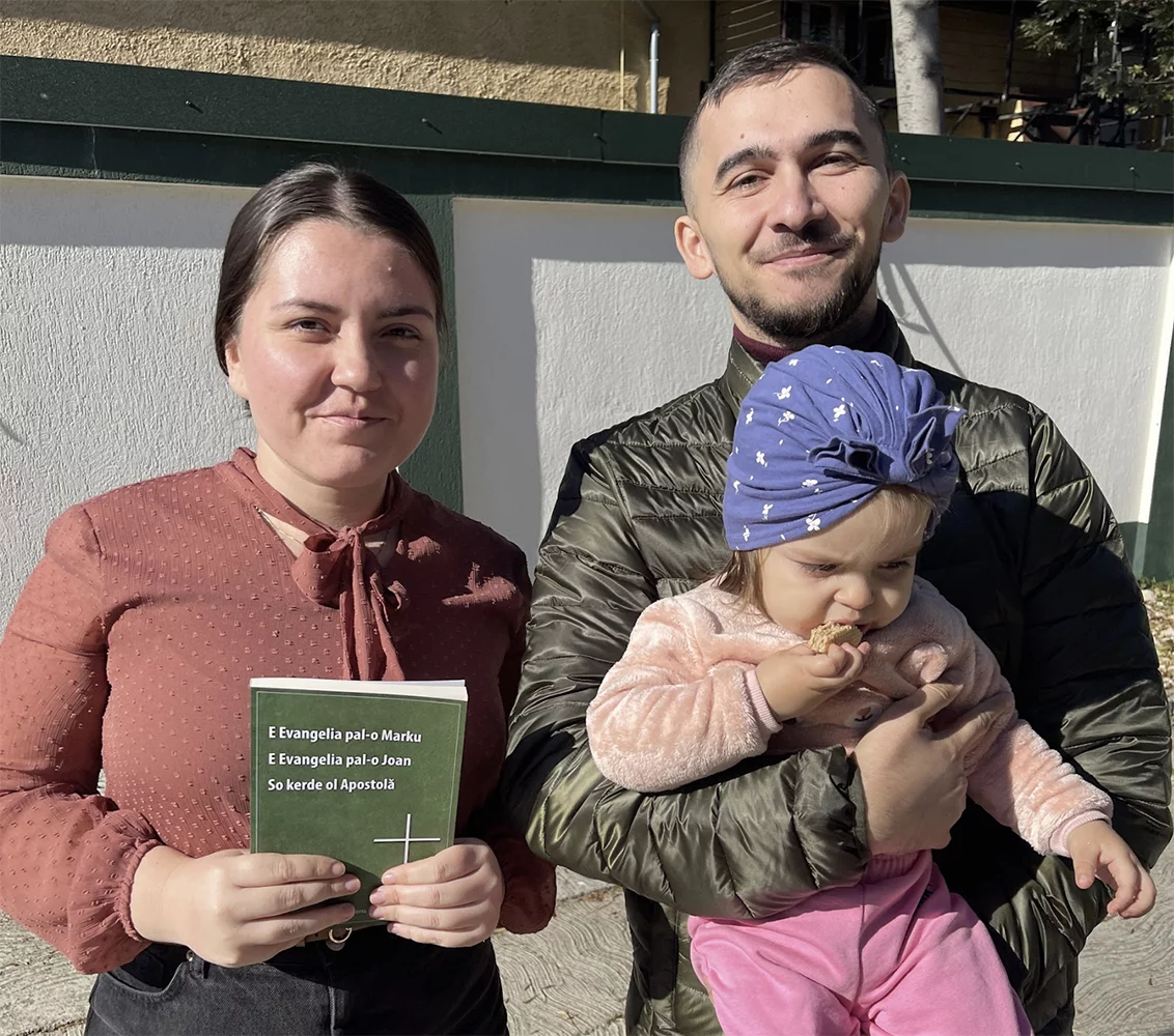 Image of Bible translators Alex and Daniel with daughter Miriam and the Standard Romani books of Mark, John and Acts